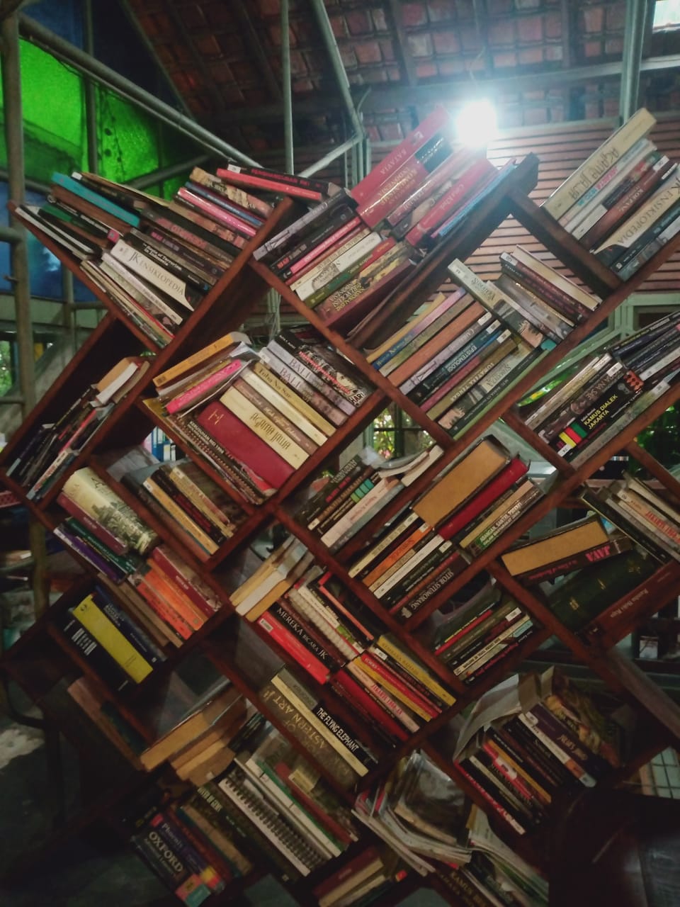 Rak buku di kantor redaksi Komunitas Bambu (Sumber: dokumentasi pribadi)