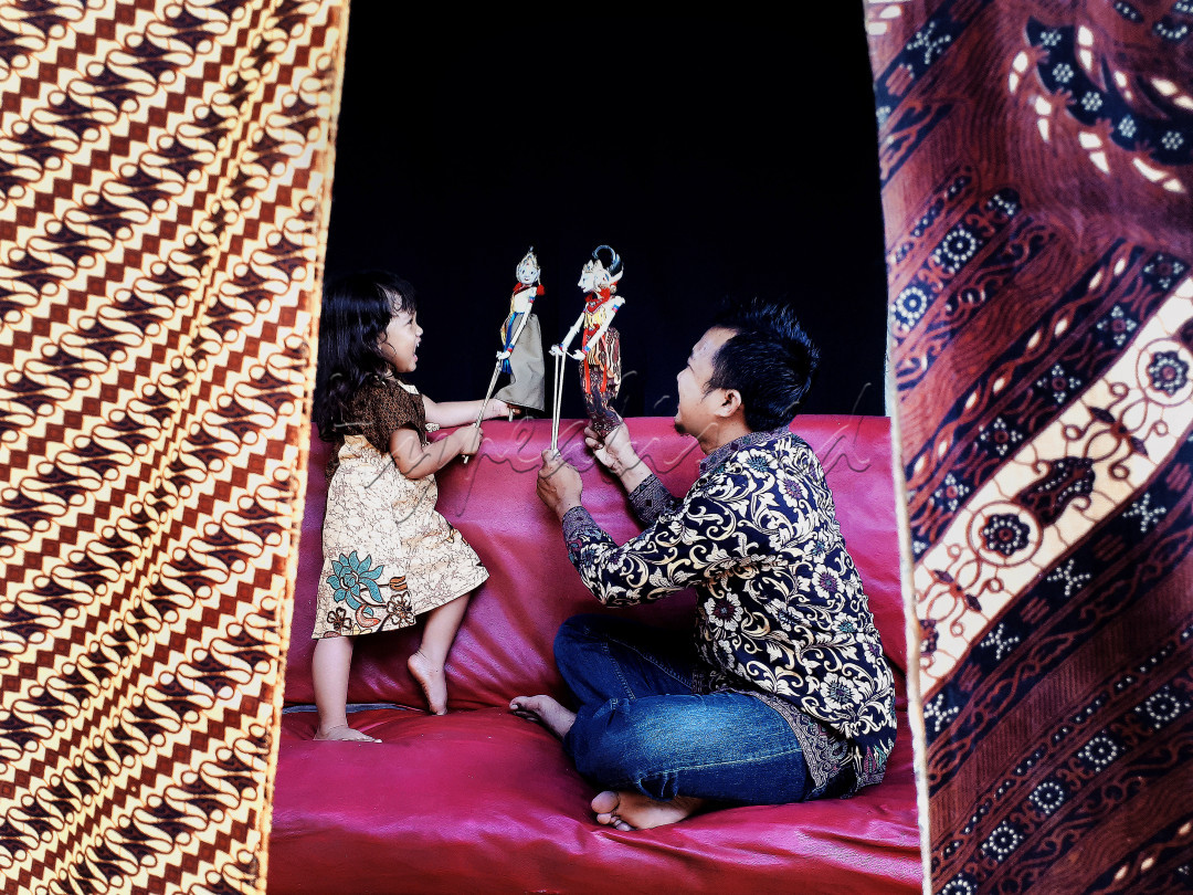 Dimusim pandemi ini, kita harus selalu mengikuti anjuran pemerintah, salah satunya yakni kita harus tetap dirumah saja.<br />
Meskipun dirumah, kita juga bisa melakukan kegiatan yang bermanfaat dan menyenangkan.<br />
Seperti yang terlihat difoto ini, terlihat ada anak yang sedang bermain wayang dengan ayahnya.<br />
Ekspresi anak dan ayahnya tersebut juga terlihat sangat senang dan bahagia, meskipun hanya bermain dirumah saja.<br />
Dengan kegiatan tersebut, anak juga bisa bermain sambil belajar tentang kesenian tradisional.