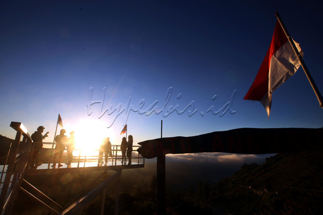 Wisatawan menikmati pemandangan matahari terbit dari Batu Angkruk Dieng, Kabupaten Wonosobo, Jawa Tengah.